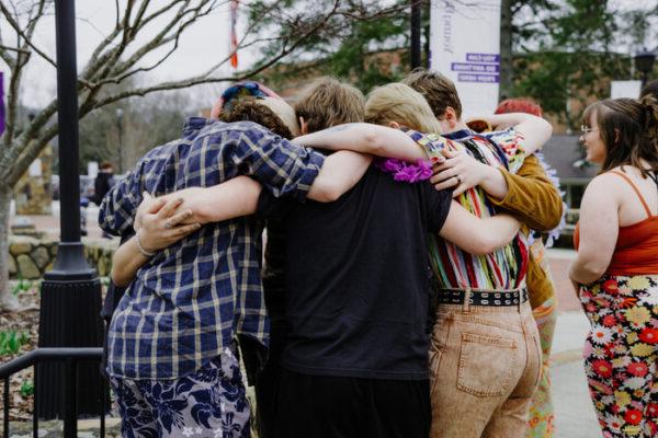 a group of people holding each other