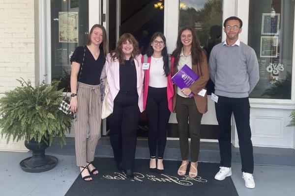 a group of people standing in front of a door