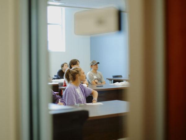 a group of people sitting at a desk